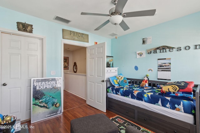 bedroom with visible vents, a ceiling fan, and wood finished floors