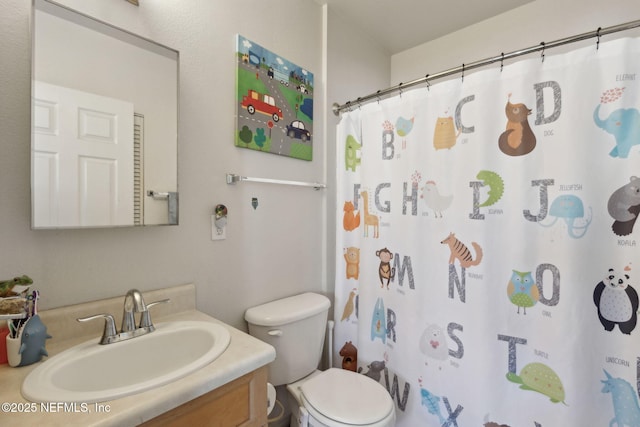 full bathroom featuring toilet, vanity, and a shower with curtain