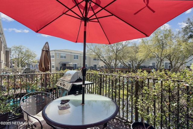 balcony with outdoor dining area and a grill