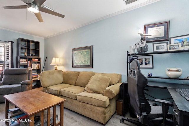 office space with visible vents, ceiling fan, and ornamental molding