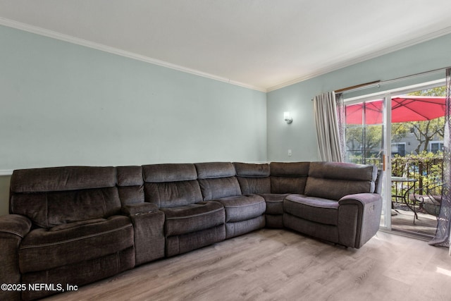 living area featuring ornamental molding and wood finished floors