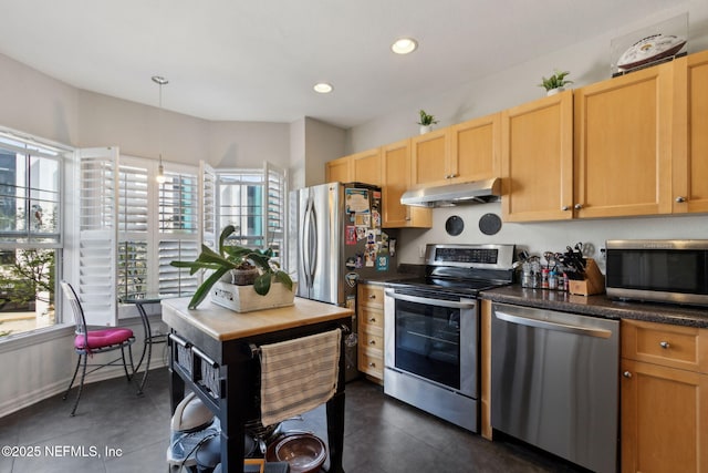 kitchen with light brown cabinets, recessed lighting, under cabinet range hood, appliances with stainless steel finishes, and dark countertops