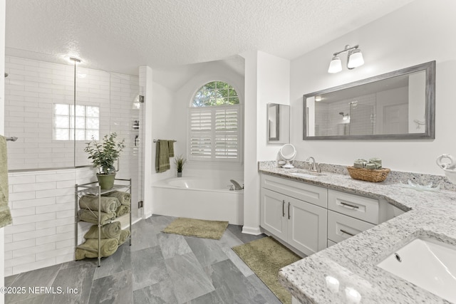 full bath featuring a sink, a garden tub, a stall shower, and double vanity