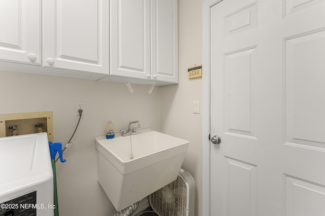 laundry room with a sink, washer / clothes dryer, and cabinet space