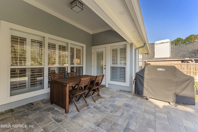 view of patio / terrace with grilling area, outdoor dining area, and fence