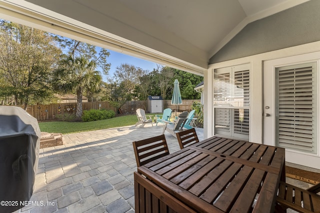 view of patio featuring grilling area, outdoor dining area, and a fenced backyard