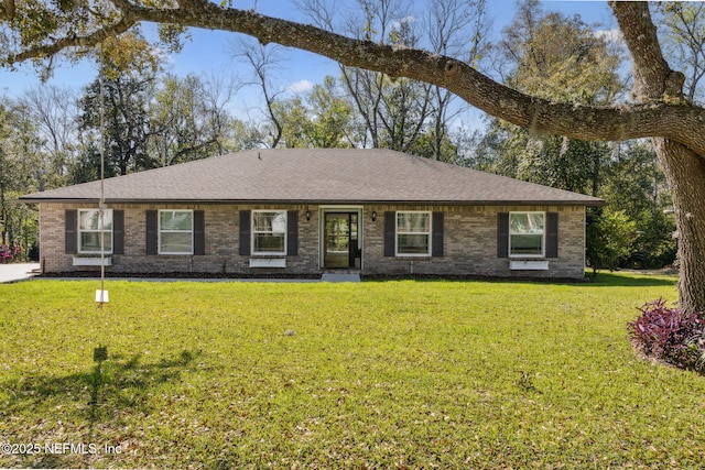 ranch-style home with brick siding, roof with shingles, and a front lawn