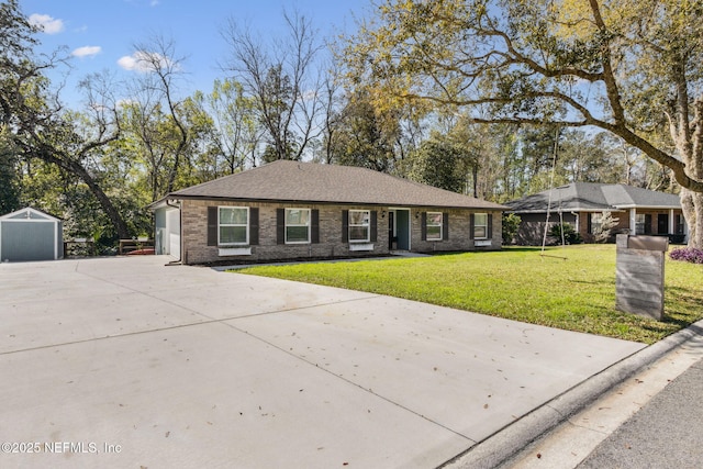 view of front facade with brick siding, concrete driveway, and a front yard