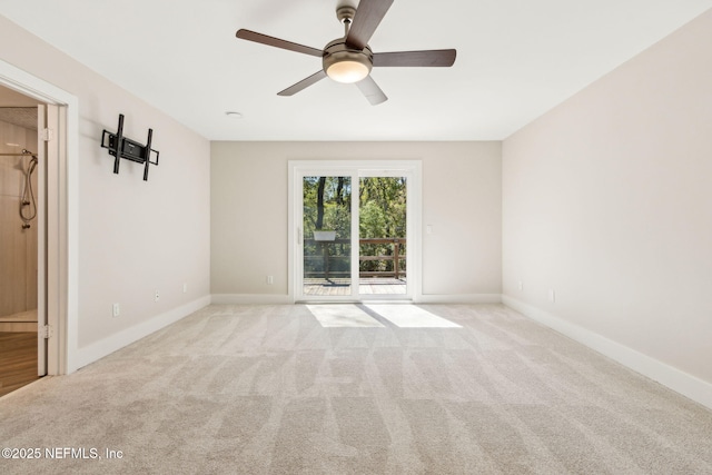 carpeted empty room featuring baseboards and ceiling fan