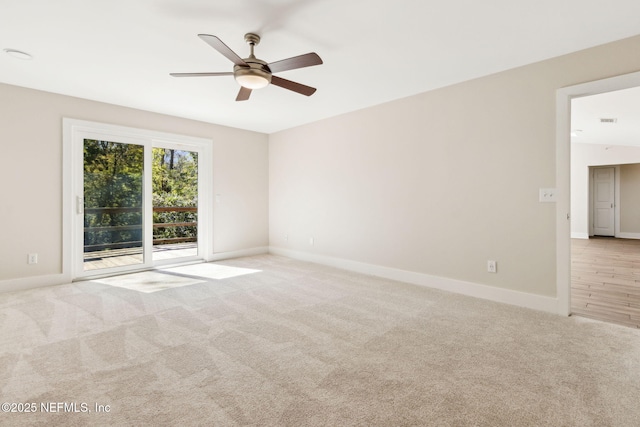 spare room featuring ceiling fan, baseboards, and light carpet