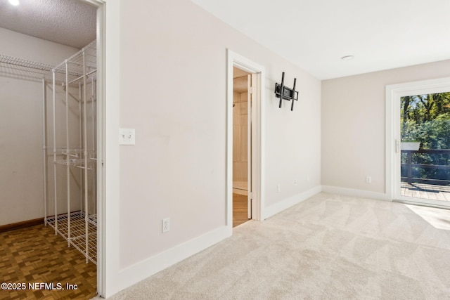 unfurnished bedroom featuring a closet, baseboards, and access to outside