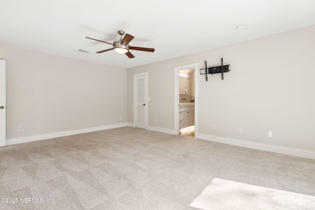 unfurnished room featuring visible vents, light carpet, baseboards, and a ceiling fan