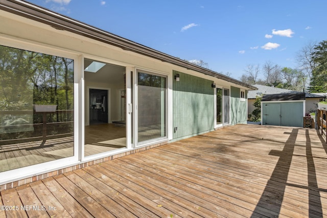 deck featuring a storage shed and an outdoor structure