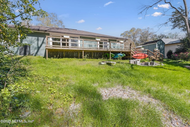 rear view of property featuring a wooden deck