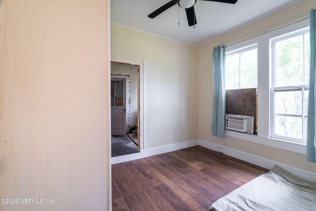 346 N Cherry St, Starke, FL 32091 - unfurnished bedroom featuring crown molding, cooling unit, wood finished floors, baseboards, and ceiling fan