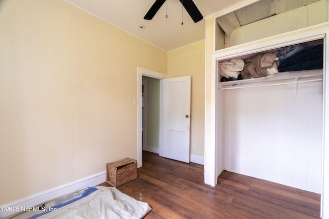 346 N Cherry St, Starke, FL 32091 - unfurnished bedroom with crown molding, a closet, wood finished floors, and ceiling fan