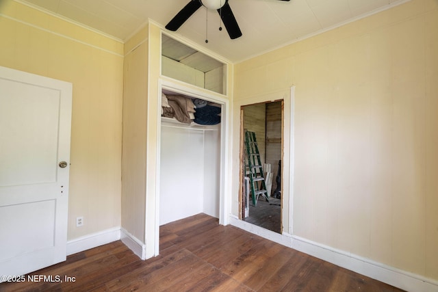 346 N Cherry St, Starke, FL 32091 - unfurnished bedroom with a closet, a ceiling fan, dark wood-type flooring, baseboards, and ornamental molding