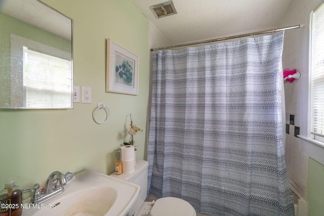 346 N Cherry St, Starke, FL 32091 - full bath with visible vents, toilet, a sink, and a healthy amount of sunlight
