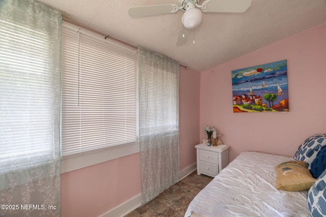 346 N Cherry St, Starke, FL 32091 - bedroom featuring baseboards, a textured ceiling, and ceiling fan