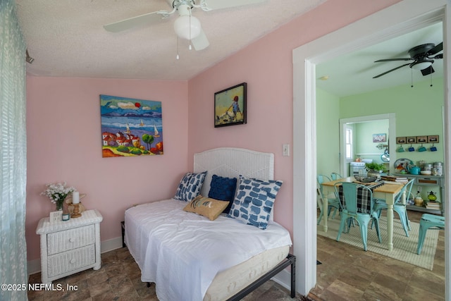 346 N Cherry St, Starke, FL 32091 - bedroom featuring baseboards, a textured ceiling, and a ceiling fan