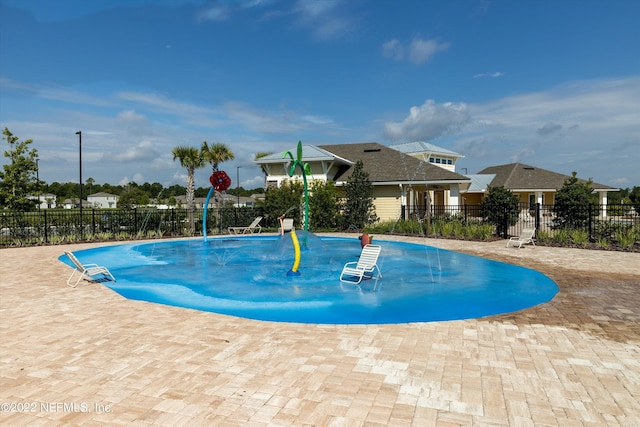 view of swimming pool with a patio area, a pool, and fence