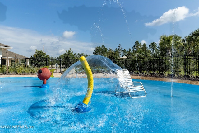 view of swimming pool with fence