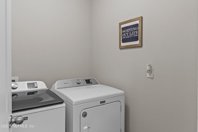 clothes washing area featuring washer and clothes dryer and laundry area