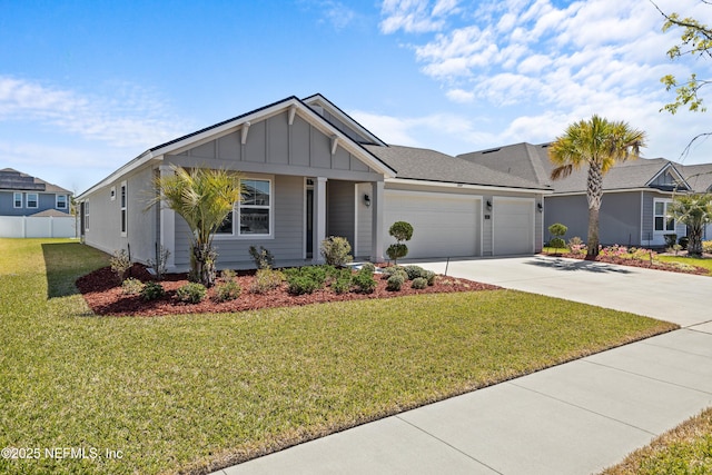 view of front of house with a front lawn, an attached garage, board and batten siding, and driveway