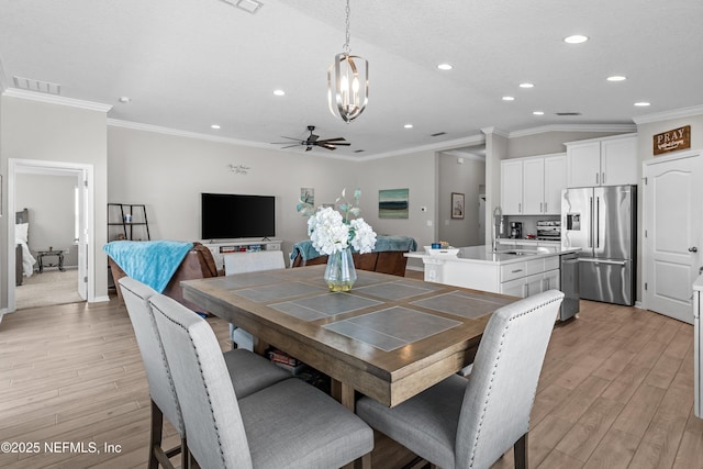 dining area featuring light wood-type flooring, visible vents, ornamental molding, ceiling fan with notable chandelier, and recessed lighting