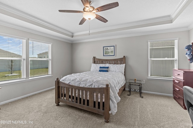 bedroom featuring a raised ceiling, ornamental molding, baseboards, and light carpet