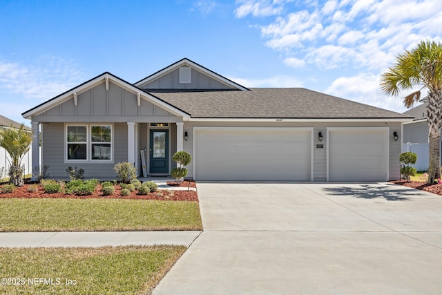 view of front of house featuring board and batten siding, a shingled roof, a front lawn, concrete driveway, and a garage