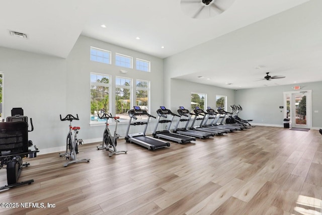 workout area featuring light wood-style flooring, visible vents, ceiling fan, and a healthy amount of sunlight