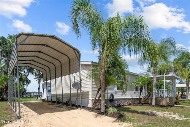 view of parking / parking lot with a detached carport and driveway