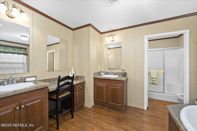 bathroom featuring a sink, visible vents, and wood finished floors