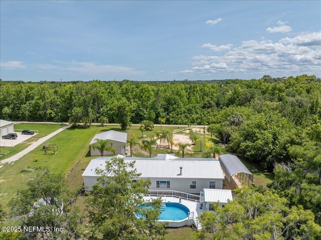 birds eye view of property featuring a view of trees