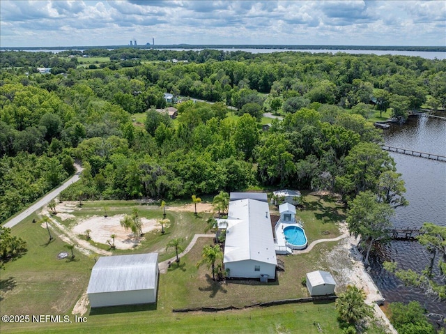 birds eye view of property featuring a view of trees and a water view