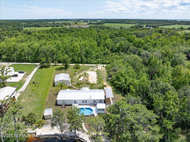 birds eye view of property with a forest view