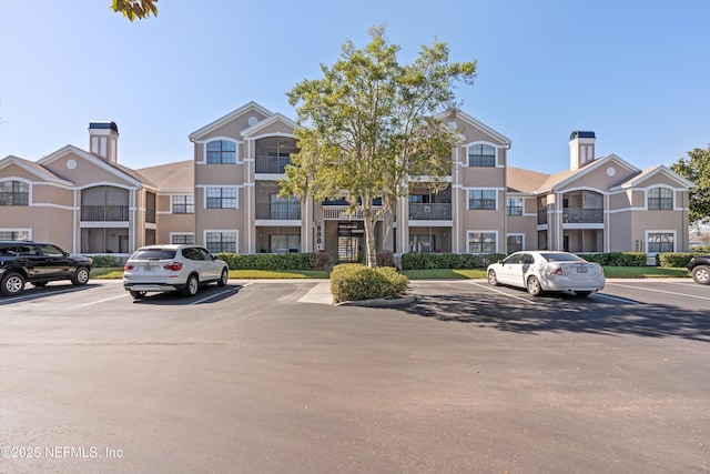 view of property with a residential view and uncovered parking