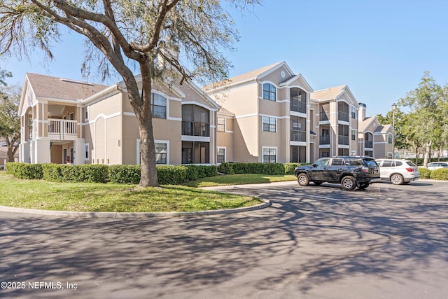 view of property featuring uncovered parking