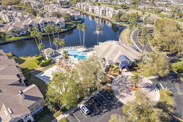 drone / aerial view with a residential view and a water view