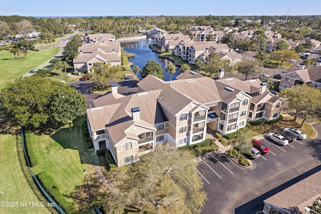 drone / aerial view featuring a residential view and a water view