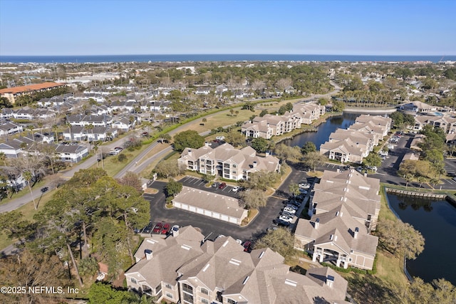 bird's eye view with a residential view and a water view