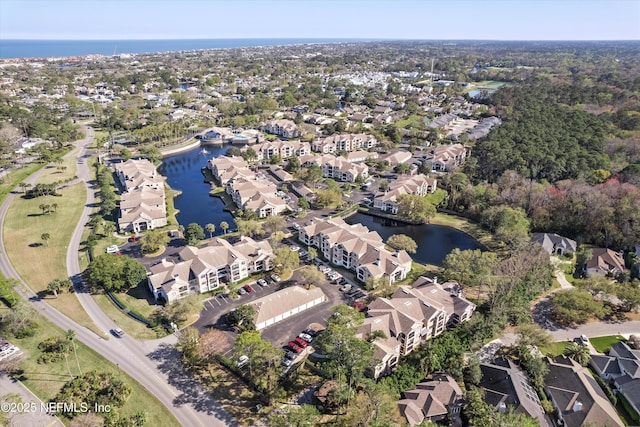 bird's eye view featuring a residential view and a water view