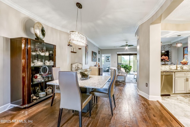 dining space with ceiling fan, ornamental molding, and hardwood / wood-style flooring