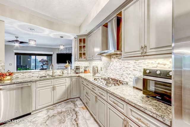 kitchen with a sink, decorative backsplash, stainless steel appliances, wall chimney exhaust hood, and marble finish floor