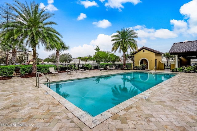 pool featuring a patio area and fence