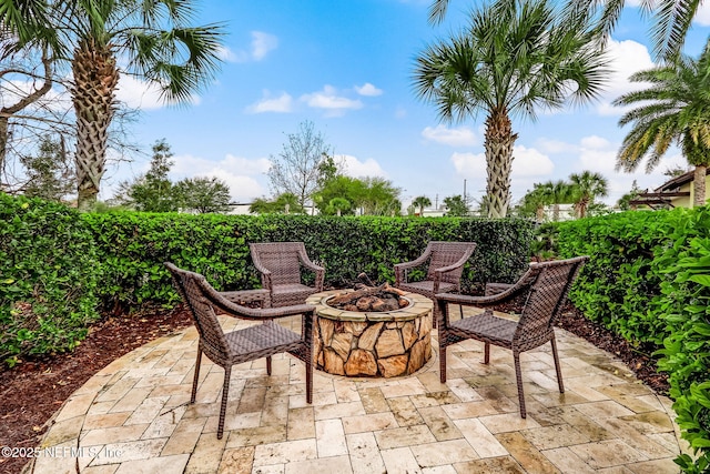 view of patio / terrace featuring fence and a fire pit