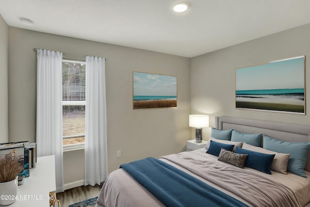 bedroom featuring baseboards and wood finished floors