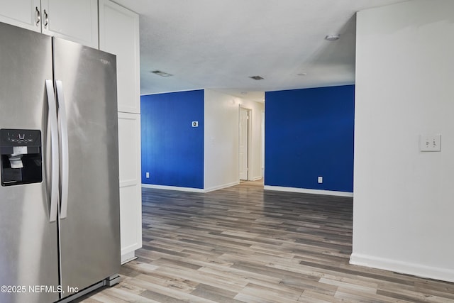 395 Arora Blvd, Orange Park, FL 32073 - kitchen featuring visible vents, stainless steel refrigerator with ice dispenser, wood finished floors, white cabinets, and baseboards
