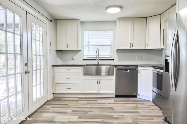 395 Arora Blvd, Orange Park, FL 32073 - kitchen featuring a sink, light wood-type flooring, appliances with stainless steel finishes, and white cabinets